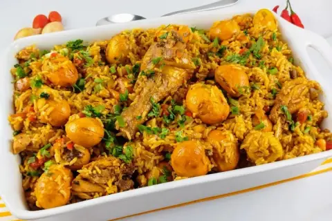Un plat brésilien poulet savoureux, riz parfumé, morceaux de poulet et œufs dorés, garni de persil frais.