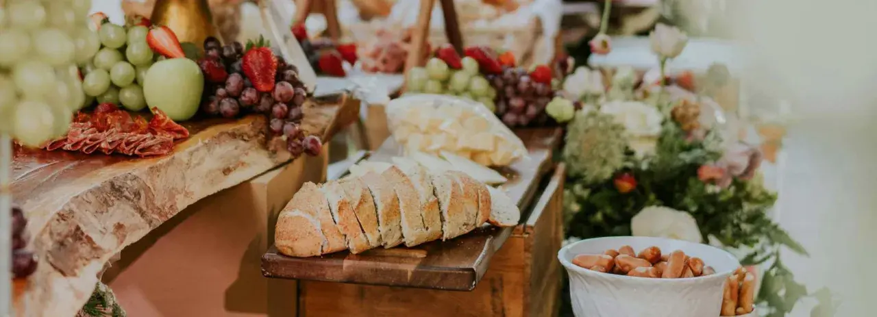 Plateau de charcuterie et fromages, fruits frais, pain et saucisses. Une belle idée repas mariage simple et gourmande.