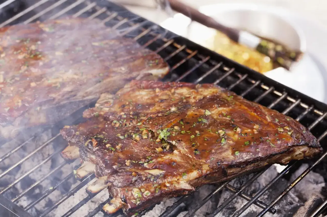 Une surprise de porc barbecue, des côtes charnues et savoureuses grillent sur le feu, dégageant une fumée alléchante.