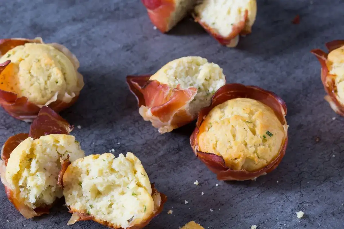 Délicieux muffin salé enveloppé de fines tranches de prosciutto, parfaits pour un apéritif gourmand.